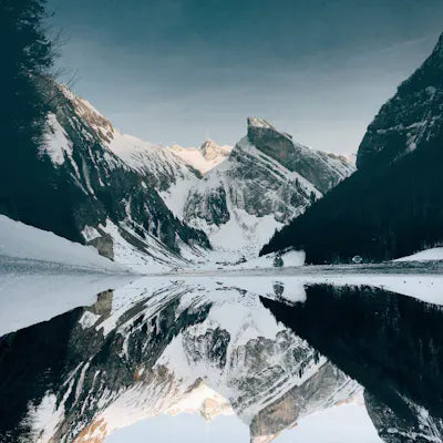 Snow-covered mountains reflected in a lake