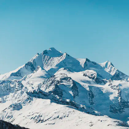 Snow-covered peak under a blue sky