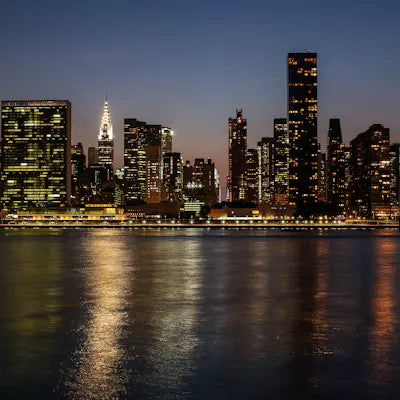 Skyline at night with lights reflected in the water