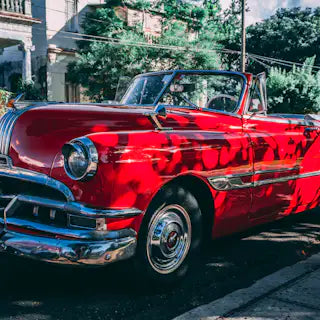 Red classic convertible by the roadside