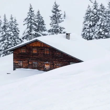Wooden cabin in deep snow
